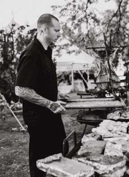 Chef W. overseeing lamb on a spit
